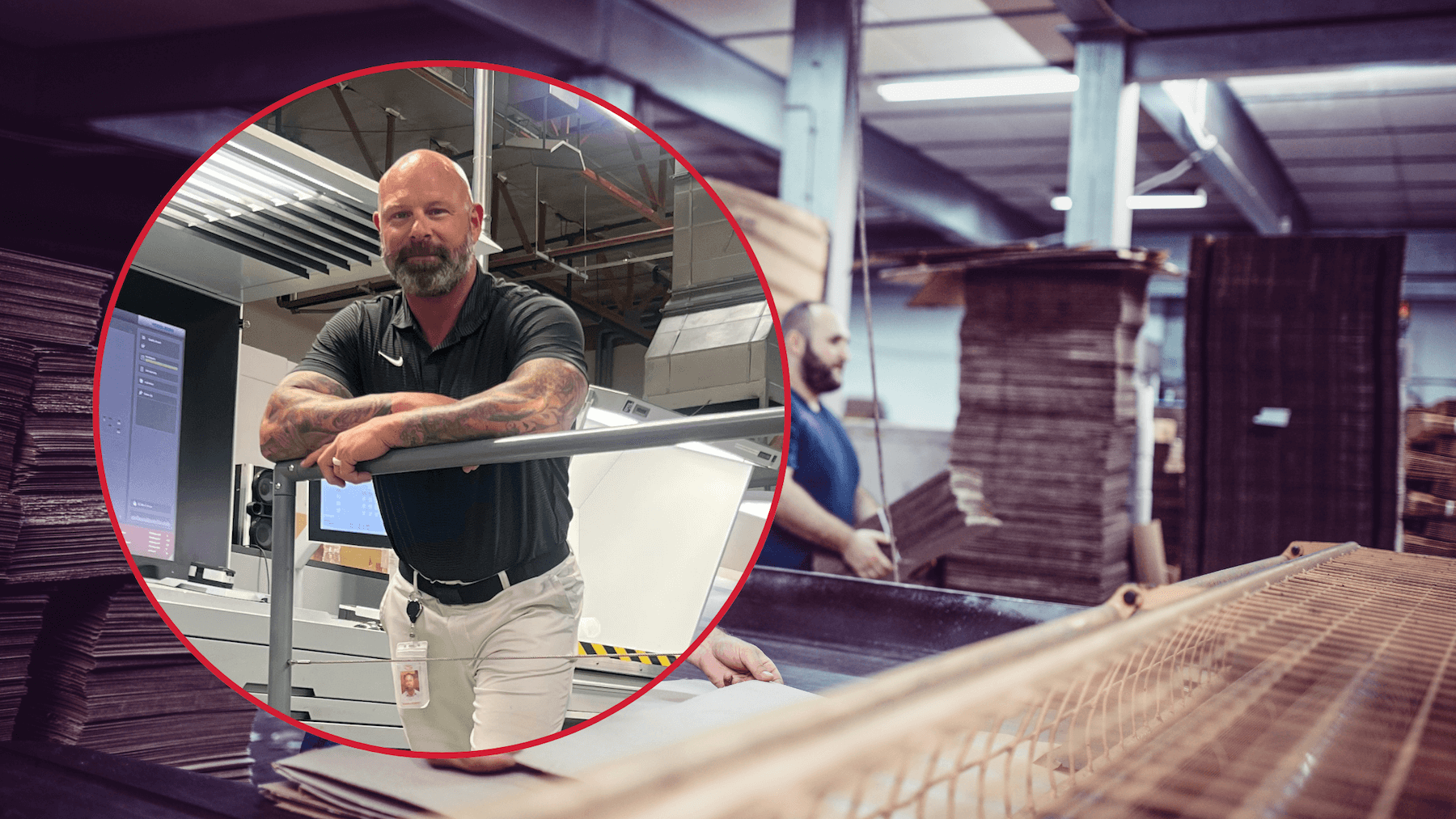 Man in printing facility with machinery.