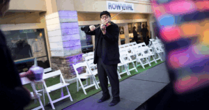 Nico playing the violin at an outdoor event, representing a successful and fulfilling creative service trade career in music performance.