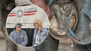 An apprentice farrier holding a horse's hoof while fitting a metal horseshoe, showcasing the precision and traditional craftsmanship involved in the farrier trade.
