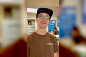Butcher career inspiration — David, a butcher at a La Jolla market, smiling at the counter after moving up from the grocery department through on the job training