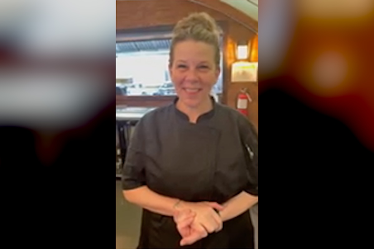 Chef career inspiration — Shannon, a back of house supervisor and chef, smiling in her chef coat at the restaurant